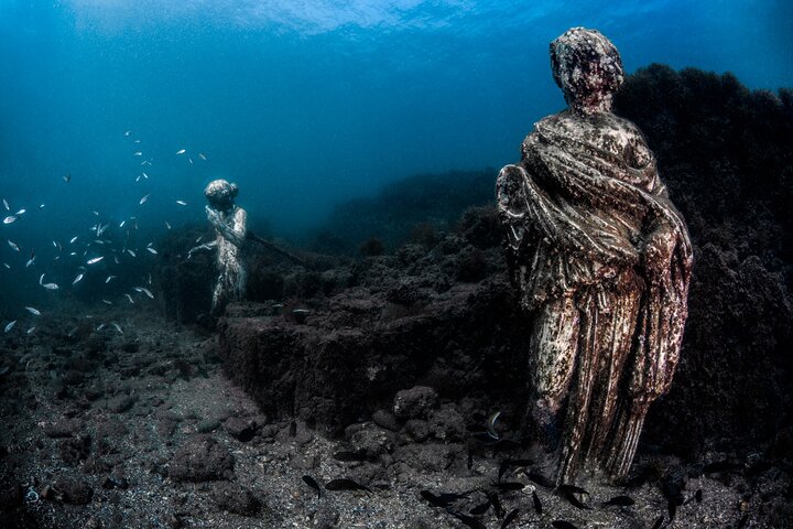 Plongeur au-dessus d'une mosaïque romaine immergée, entouré de poissons