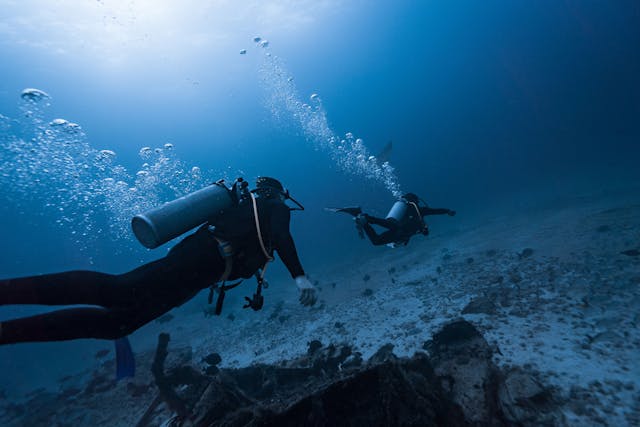 Plongeurs explorant un fond sableux en eau profonde