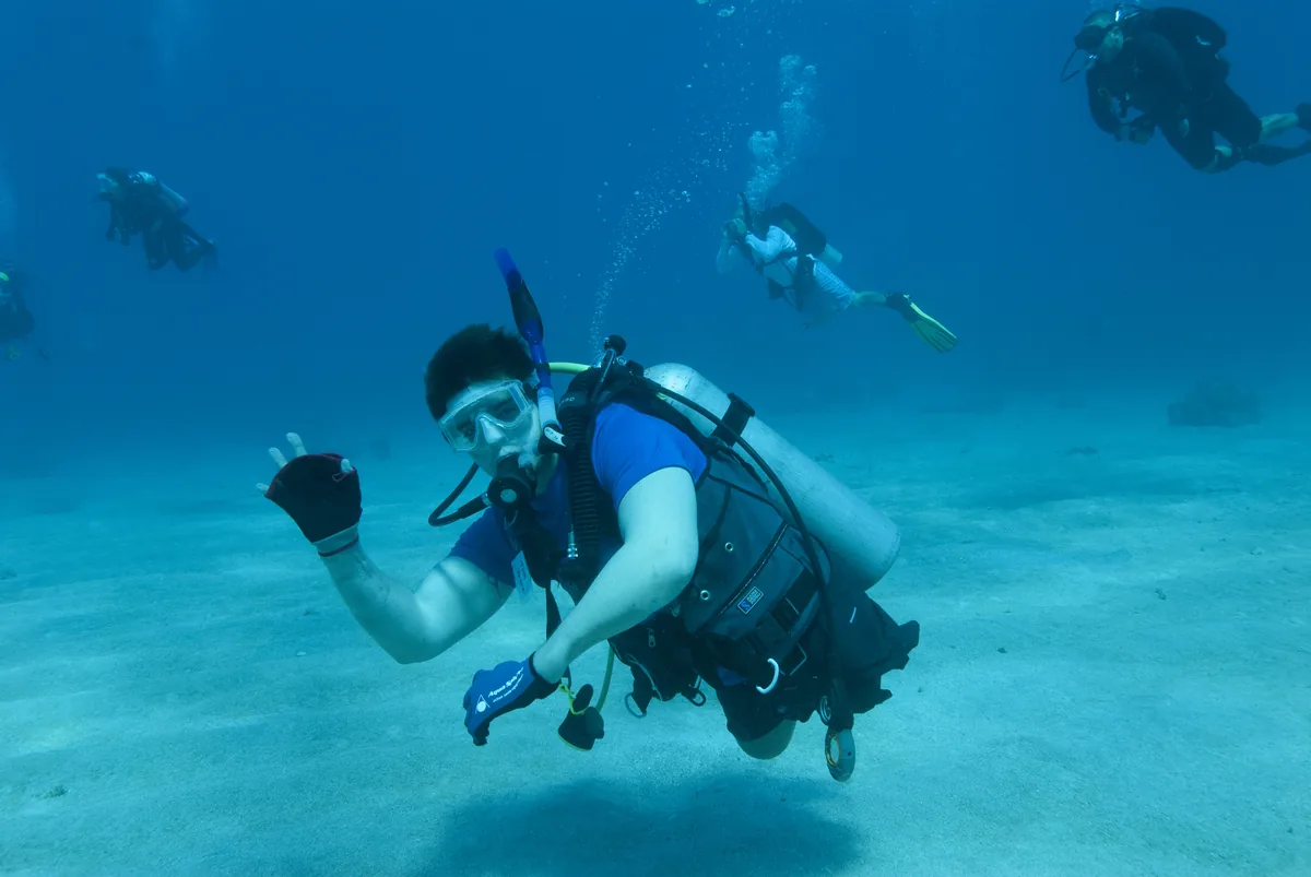Diver with a disability, wounded veteran, during a dive after certification